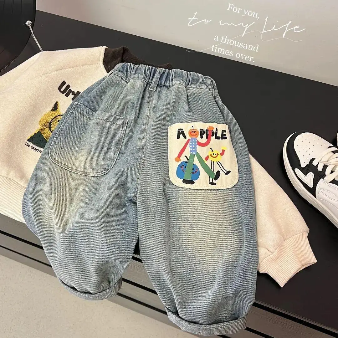 S7a6360a2f6a54157b2017e1c6c6aeffbP.webp 2026 New Spring Childrens Pants Fun Cartoon Print Patch Pocket Boys Jeans Elastic Waist Loose Denim Trousers