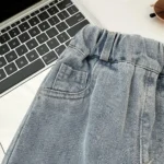2026 New Spring Childrens Pants Fun Cartoon Print Patch Pocket Boys Jeans Elastic Waist Loose Denim Trousers